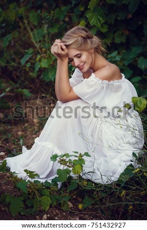 Beautiful blond girl with basket of grapes in a vineyard. Romantic, in the style of Provence, a gentle image