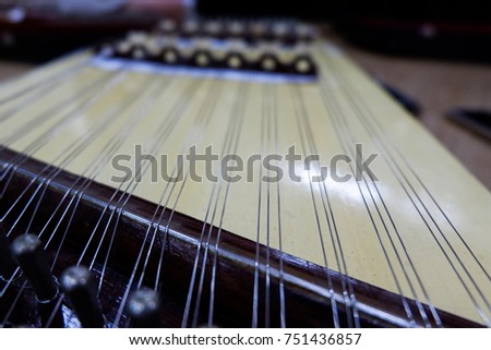 a percussion instrument of traditional Thai origin, constructed on a similar principle to the piano and played with two sticks
