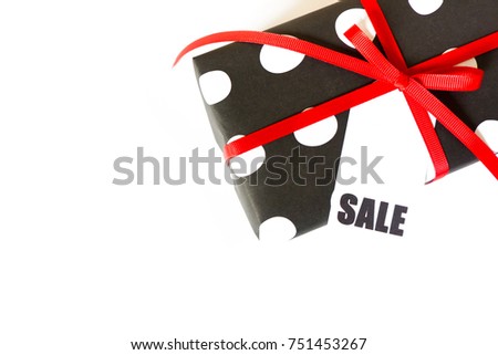 Black and white gift box. White background. Black Friday. Red ribbons.