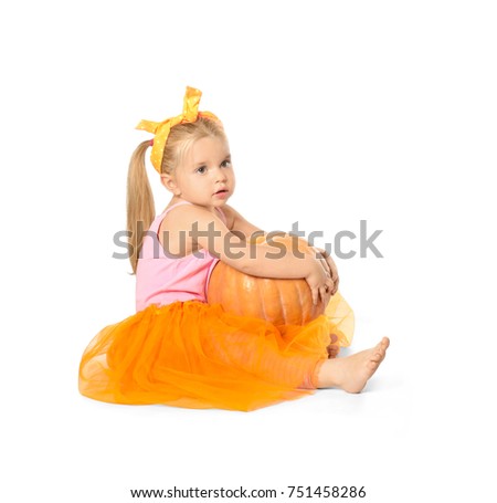 Adorable little girl with pumpkin on white background