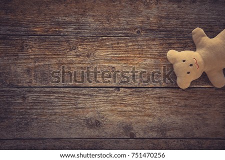 Adorable teddy bear on toned wooden background. Space for text