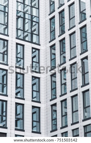 details of the facade of a modern skyscraper made of glass and steel closeup.