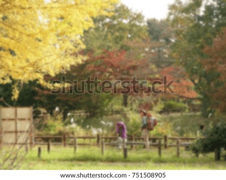 blurred photo of taking a photo of beautiful yellow ginkgo tree in autumn season in Tokyo, japan