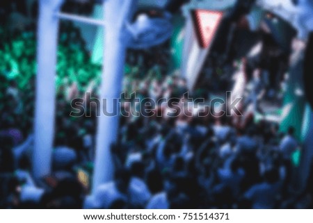 Blurred for background. Night club dj party people enjoy of music dancing sound with colorful light with Smoke Machine and lights show. Hands up in the earth.