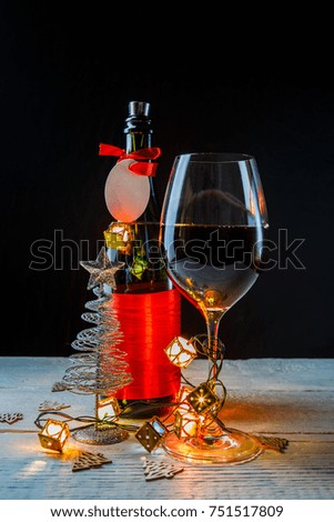 New Year's image of bottle with red ribbon, Christmas tree toys, wine glass