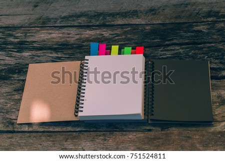 Minimal work space: blank notebook with colors note tab on old wooden table, picture copy space for art work design ad or add text message. Case study concept