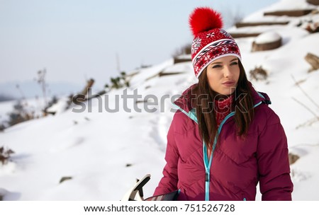 winter, leisure, sport and people concept - happy young woman in red hat outdoors