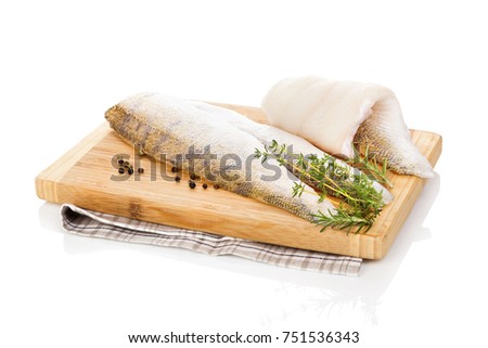 Fillet fish slices on wooden chopping board isolated on white background. Luxurious seafood eating.