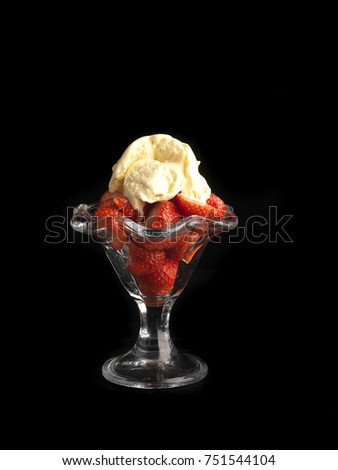 strawberries salad with ic...am on black background