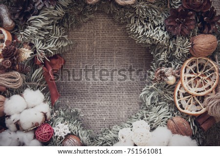 Christmas wreath with xmas tree wooden background, cotton and needles, happy sunny day