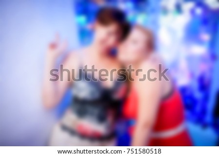 Blurred for background. Ibiza night club. People  smiling and posing on cam during concert in night club party. Man and woman have fun at club. Boy and girl at night club party