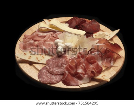 mixed cold cuts and cheese on a wood dish