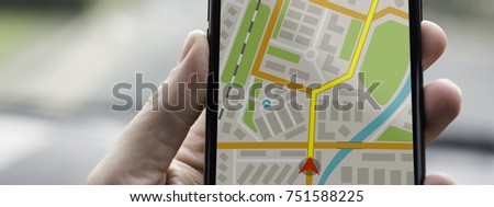 GPS Navigation on Mobile Phone Device and Transportation Concept. Male Hand Using Navigation System Map Tracking on Smartphone with Copy Space.