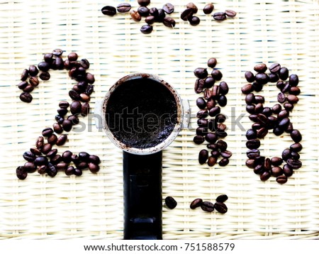 Coffee bean create in Letter word of number of  Two thousand eighteen 2018 on texture Background, Happy New Year and Holidays Concept