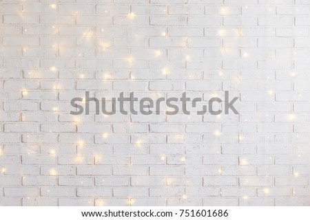 white brick wall christmas background with shiny lights
