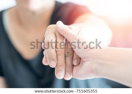 Caregiver, Specialized Assistance, carer hand holding elder hand woman in hospice care. Philanthropy kindness to disabled concept.Public Service Recognition Week Royalty-Free Stock Photo #751605355