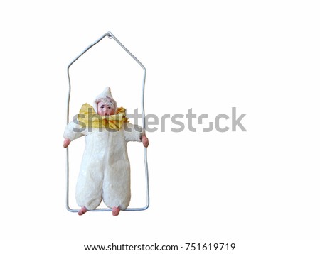Vintage Christmas tree toy in the form of a clown on a trapeze (isolated on a white background).      