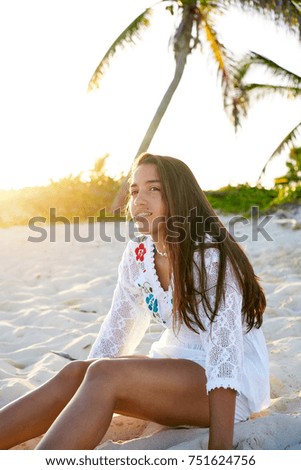 Latin beautiful girl sunset in Caribbean beach sand sitting relaxed