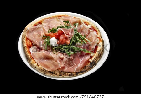 pizza with raw parma ham and fresh salad