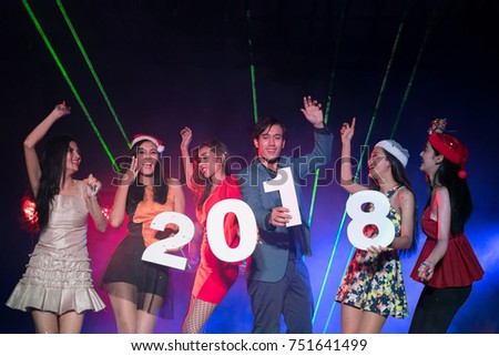 Group of funny friends company in luxury outfits with xmas headwear.Holding 2018 number latter.Amazed cheerful people laughing at the club at new year. Entertain and night life mode concept.