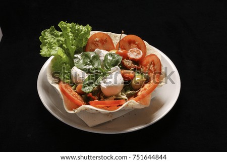 salad with tomatoes, dried...pers in a piadina bowl