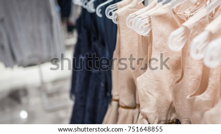 Women's dresses on hangers in a clothing store