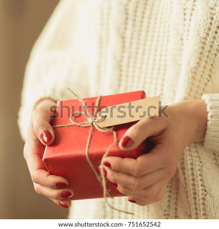Picture of lady holding small new year gift