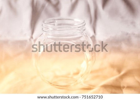 Glass bottles are placed on the fabric floor with sunlight shining through in the morning.