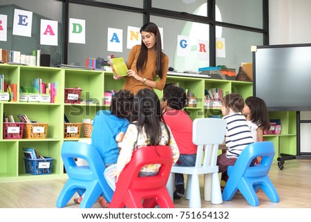 teacher attend in teaching preschool kids kindergarten to learning in the class room together Royalty-Free Stock Photo #751654132