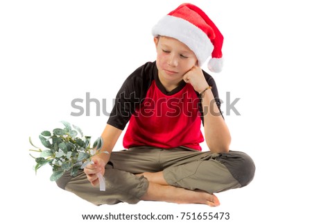 Sad pre-teen boy with mistletoe isolated on white background