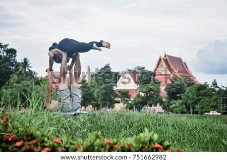 Slim girl play yoga on the lawn at the park,relax in nuture,Asian Girls love health practicing yoga
