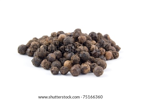 the spice black peppercorns in a pile isolated on white