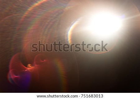 Lens flare light over black background.