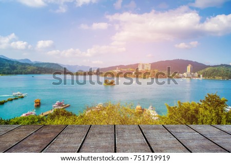 Wooden table top on beach and green water sea background for display or montage product.