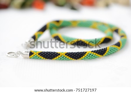 Bead crochet necklace in colors of Jamaican flag close up