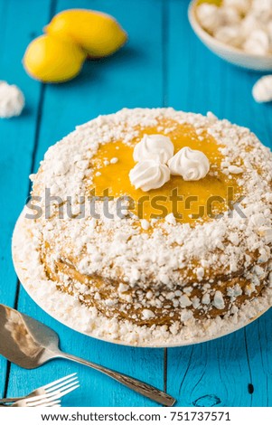 Tasty Homemade Lemon Meringue Pie or Cake on Blue Wooden Table