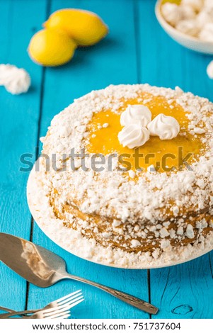 Tasty Homemade Lemon Meringue Pie or Cake on Blue Wooden Table
