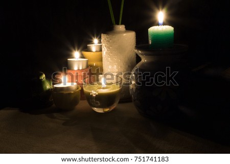 candles light on the table with small vase or jars