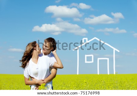 Image of happy couple in yellow meadow with drawn house on background
