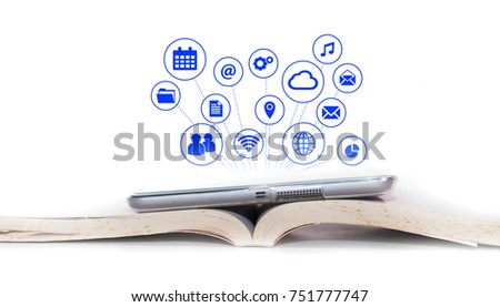 E-Reader Concept.The un recognize Tablet device on an open old books with internet and social media graphic icon come out from the tablet device.Education and technology.