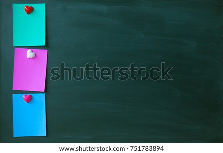 color sticky paper notes on magnet chalk blackboard with copy space for design or add text message. Education concept.