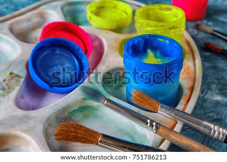 Gouache paints and art brushes for the artist with a copy space