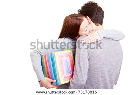 Happy woman with gift thanking her boyfriend with a hug