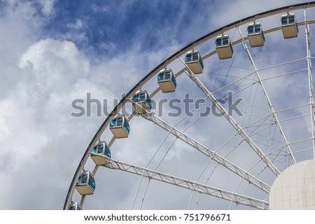 City under the blue sky white cloud ferris wheel