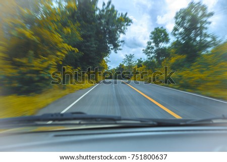 Car driving fast into forest 