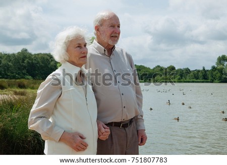 Elderly man holding elderly woman's hand