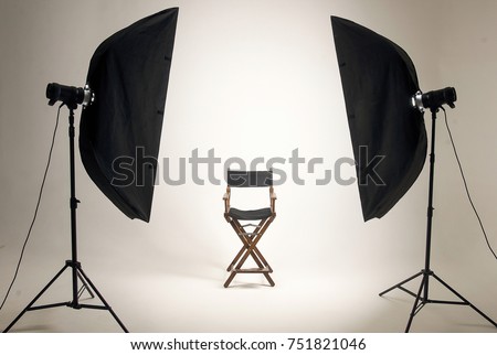Empty photo studio with lighting equipment. Space for text. Vacant chair. The concept of selection and casting. Screensaver for your desktop. Royalty-Free Stock Photo #751821046