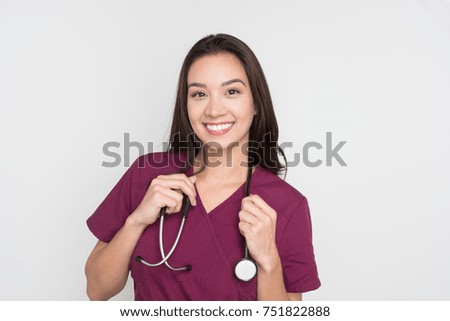 Happy female nurse posing in her scrubs