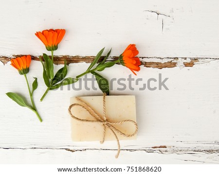 Handmade spa calendula soap on vintage wooden background. Soap making. Soap bars. Spa, skin care. Top view. Flat lay.	
