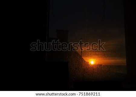 beautiful sunrise scenery view through a murky window on autumn morning